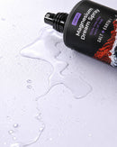 Salt + Earth Co. Magnesium Dream Spray laying on purple bench top with dream spray spilt on the bench